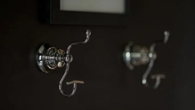 Silver bathroom towel hooks mounted on wall