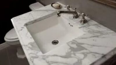 Bathroom vanity with marble countertop and silver faucet
