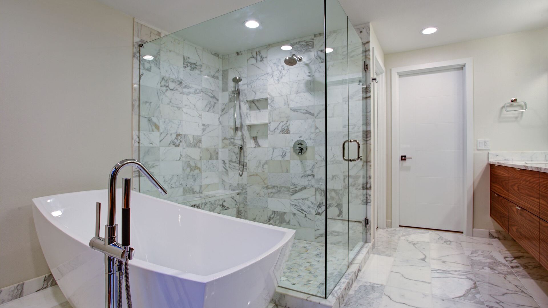Bathroom with free standing bathtub and full glass shower 
